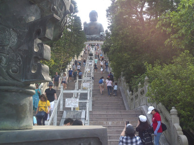 Huge staircase to Tian Tan Buddha with many devotees in Ngong Ping village, Hong Kong